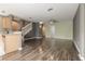 Open-concept living area with hardwood floors, and stairway access to upper level at 415 Old Farm Ln, Winter Springs, FL 32708