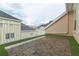 A cozy outdoor patio area with wood deck tiles, artificial grass and white gravel at 415 Old Farm Ln, Winter Springs, FL 32708