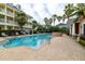 Beautiful community pool with tropical landscaping and comfortable lounge chairs for relaxing at 415 Old Farm Ln, Winter Springs, FL 32708
