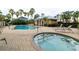 Community pool with spa, surrounded by palm trees and lush landscaping for a serene setting at 415 Old Farm Ln, Winter Springs, FL 32708