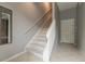 Carpeted staircase leading to the upper level, enhanced by gray walls and neutral tile flooring at 415 Old Farm Ln, Winter Springs, FL 32708