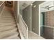 Staircase leading to upper level, complemented by neutral walls and a view of the adjacent room at 415 Old Farm Ln, Winter Springs, FL 32708