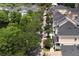 Scenic aerial view of a tree-lined street with colorful homes and manicured landscaping at 415 Old Farm Ln, Winter Springs, FL 32708