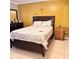 Bedroom featuring modern furniture, tile floors, and a bright yellow paint scheme at 4235 Shades Crest Ln, Sanford, FL 32773