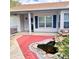 Inviting front porch with brick accents and decorative pond feature adds curb appeal at 4235 Shades Crest Ln, Sanford, FL 32773