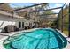 Sparkling in-ground pool with waterfall feature and screened enclosure, great for outdoor enjoyment at 4235 Shades Crest Ln, Sanford, FL 32773