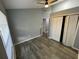 Bedroom featuring wood look flooring, neutral paint, and double bi-fold closet at 4503 Oak Arbor Cir, Orlando, FL 32808