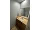Neat half bath with a standard sink, mirror, and tiled floor, efficiently utilizing space at 4503 Oak Arbor Cir, Orlando, FL 32808