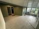 Enclosed patio with painted concrete floor, exterior doors, and screens at 4503 Oak Arbor Cir, Orlando, FL 32808