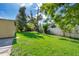 View of the home's large grassy yard, bordering the home with great outdoor space for activities and gatherings at 4524 King Cole Blvd, Orlando, FL 32811