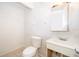 Bathroom features a toilet, sink and mirror at 4524 King Cole Blvd, Orlando, FL 32811