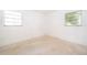 Empty bedroom featuring two windows and light colored flooring at 4524 King Cole Blvd, Orlando, FL 32811
