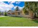 Charming single-story home with well-maintained front yard featuring a mature palm tree, enhancing curb appeal at 4524 King Cole Blvd, Orlando, FL 32811