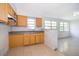 Bright kitchen featuring yellow cabinets and stainless steel sink at 4524 King Cole Blvd, Orlando, FL 32811