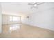 Bright living room featuring terrazzo floors, a ceiling fan, and natural light from the large window at 4524 King Cole Blvd, Orlando, FL 32811