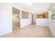 Open living area with terrazzo flooring, offering views into the adjacent dining and kitchen spaces at 4524 King Cole Blvd, Orlando, FL 32811