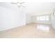 Bright living room featuring terrazzo floors, a ceiling fan, and natural light from the large window at 4524 King Cole Blvd, Orlando, FL 32811