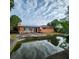View of the backyard with a patio and a pool reflecting the sky, showing an outdoor living space at 4840 Judy Ann Ct, Orlando, FL 32808