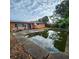 Wide shot of the backyard and swimming pool reflecting the sky at 4840 Judy Ann Ct, Orlando, FL 32808