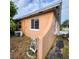 Angle view of the back of the house showing the windows and painted block wall at 4840 Judy Ann Ct, Orlando, FL 32808
