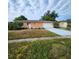Charming single-story home featuring a light orange exterior and a spacious two-car garage at 4840 Judy Ann Ct, Orlando, FL 32808