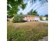 Charming single-story home with a well-maintained front yard, white door and a paved driveway at 4840 Judy Ann Ct, Orlando, FL 32808