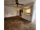 Cozy living room featuring a ceiling fan and view into the kitchen at 4840 Judy Ann Ct, Orlando, FL 32808