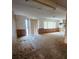Spacious living room featuring carpet floors, wood paneling, fireplace and natural light at 4840 Judy Ann Ct, Orlando, FL 32808