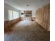 Spacious living room featuring carpet floors, wood paneling, fireplace and natural light at 4840 Judy Ann Ct, Orlando, FL 32808