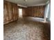 Spacious living room featuring carpet floors, wood paneling and natural light from windows at 4840 Judy Ann Ct, Orlando, FL 32808