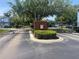Gated community entrance with lush greenery, offering security and privacy to Placid Lake residents at 514 Wilton Cir, Sanford, FL 32773
