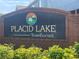 Welcoming entrance sign for Placid Lake Townhomes, showcasing a community with well-maintained landscaping at 514 Wilton Cir, Sanford, FL 32773