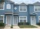A charming blue two-story townhouse with gray trim offers inviting curb appeal at 514 Wilton Cir, Sanford, FL 32773