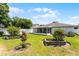 This backyard features a lush lawn, mature trees, and a privacy fence, creating a serene outdoor space at 520 Farmingham Ct, Oviedo, FL 32765