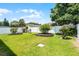 A manicured backyard featuring a lush green lawn and decorative shrubbery, all secured by a white privacy fence at 520 Farmingham Ct, Oviedo, FL 32765