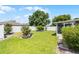 A well-maintained backyard with healthy green grass and lush landscaping, complete with a white privacy fence at 520 Farmingham Ct, Oviedo, FL 32765