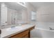 Bathroom with a combination shower and bathtub, a large mirror and neutral decor at 520 Farmingham Ct, Oviedo, FL 32765