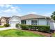 Charming single-story home with a well-manicured lawn and mature shrubs, showcasing curb appeal and a welcoming facade at 520 Farmingham Ct, Oviedo, FL 32765