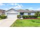Charming single-story home featuring a well-manicured lawn, attached garage, and inviting front entrance at 520 Farmingham Ct, Oviedo, FL 32765
