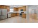 Functional kitchen with stainless steel appliances, wood cabinets, and tile flooring at 520 Farmingham Ct, Oviedo, FL 32765