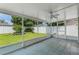 This cozy lanai has tile floors and an overhead fan; the room overlooks a large, grassy, fenced-in backyard at 520 Farmingham Ct, Oviedo, FL 32765