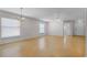 Bright, open-concept living space featuring hardwood floors, neutral paint, and elegant lighting at 520 Farmingham Ct, Oviedo, FL 32765
