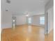 Spacious living room with hardwood floors, bright windows, and a modern ceiling fan at 520 Farmingham Ct, Oviedo, FL 32765