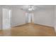 Spacious primary bedroom with hardwood floors, neutral walls, and ensuite bathroom at 520 Farmingham Ct, Oviedo, FL 32765