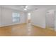 Bright main bedroom featuring wood floors, a ceiling fan, and access to an ensuite bathroom and walk-in closet at 520 Farmingham Ct, Oviedo, FL 32765