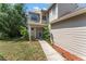 The front entrance of this home features a unique window, fresh landscaping, and walkway at 609 Northbridge Dr, Altamonte Springs, FL 32714
