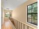 Upstairs hallway with wood floors and large windows offering natural light and views of the neighborhood at 609 Northbridge Dr, Altamonte Springs, FL 32714