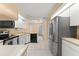 Well-lit kitchen features modern appliances, tile flooring, and an adjacent dining area at 609 Northbridge Dr, Altamonte Springs, FL 32714
