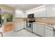 Bright kitchen featuring ample white cabinets, modern appliances, and tile flooring at 609 Northbridge Dr, Altamonte Springs, FL 32714
