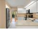 Bright kitchen with stainless steel refrigerator, tile flooring and an open layout at 609 Northbridge Dr, Altamonte Springs, FL 32714